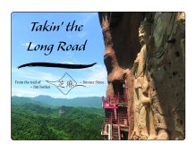 Cover image of Takin' the Long Road~ Buddha sculptures on the side of a mountain